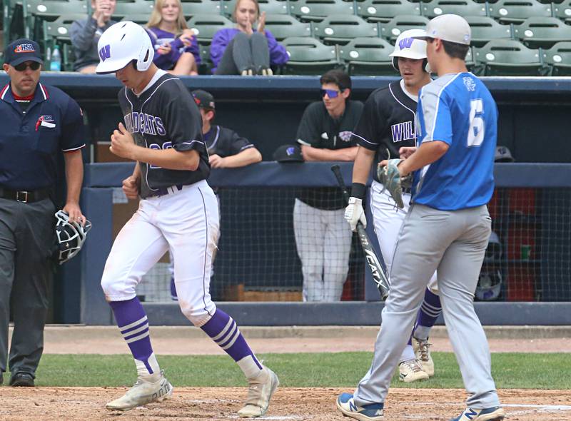 Wilmington's Ryan Kettman scores the teams first run on a pass ball from Newman pitcher Evan Bushman during the Class 2A third place game on Saturday, June 1, 2024 at Dozer Park in Peoria.