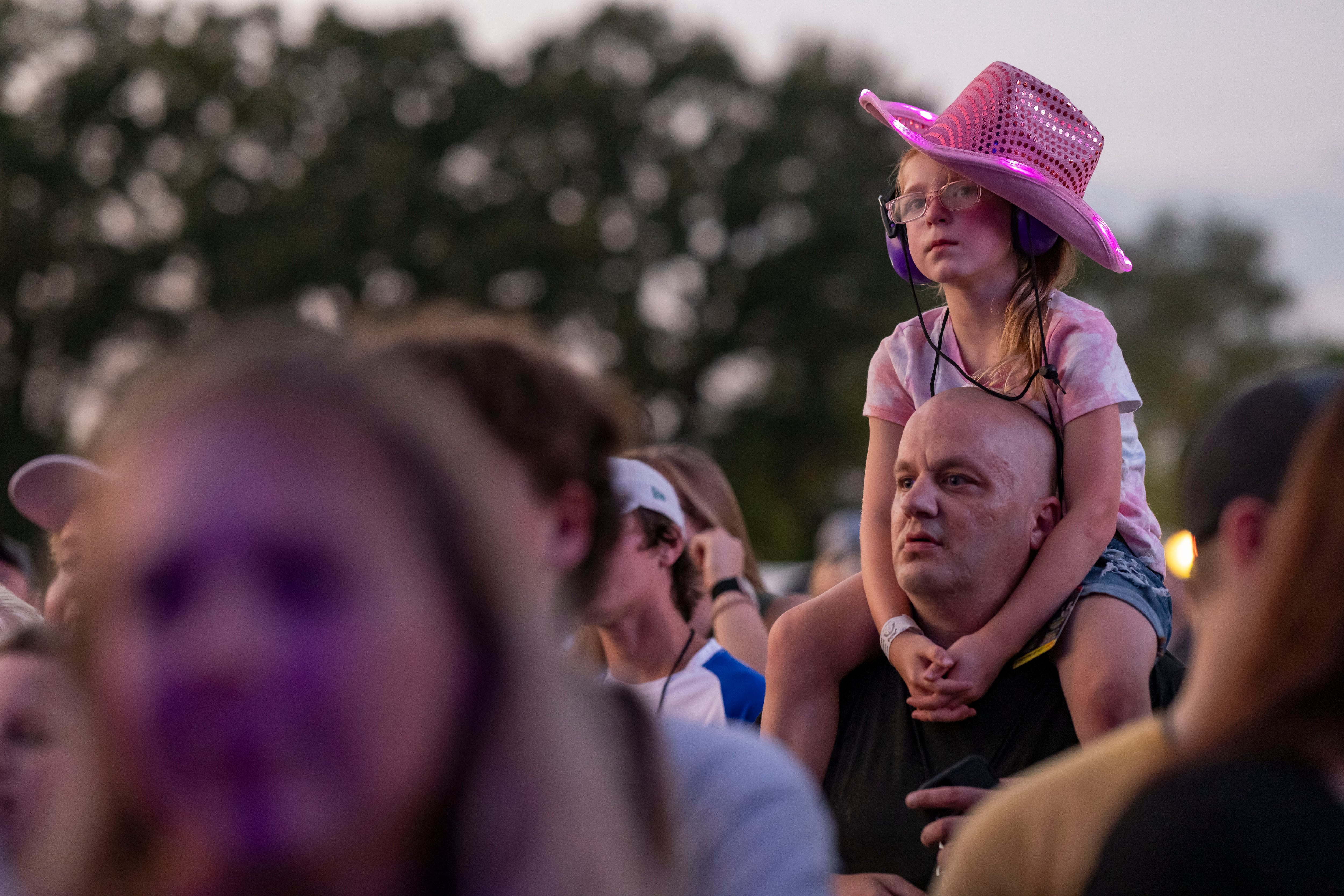 Ryleigh Steele sits atop her uncles shoulders to get a better vantage point for the Drew Baldridge concert at Streatorfest on August 2, 2024.