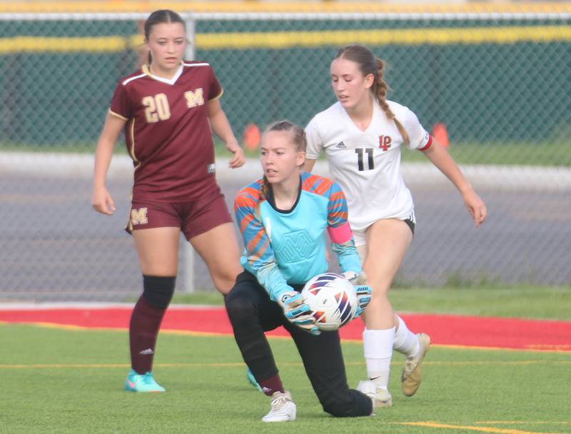 Morris keeper Maggie Stuebinger stops a shot from L-P's Danica Scoma as teammate Nicolette Boleman looks on during the Class 2A Regional semifinal game on Wednesday, May 15, 2024 at the L-P Athletic Complex in La Salle.