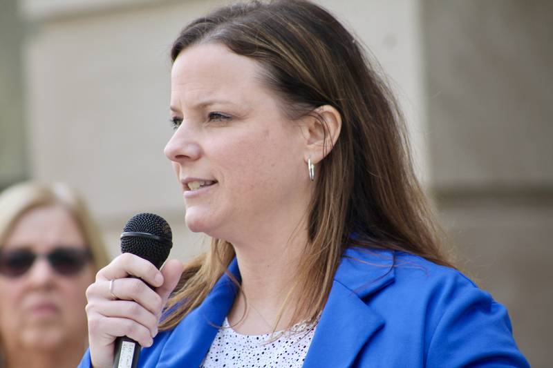 Jessica Cash, executive director at Shining Star Children's Advocacy Center, speaks to a gathering of about 50 people during the Hands Around the Courthouse event Friday, April 14, 2023 at the Old Lee County Courthouse in Dixon.