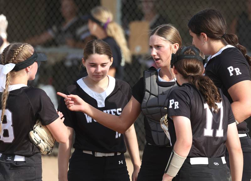 Prairie Ridge players meet on the mound during their Class 3A sectional final against Sycamore Friday, May 31, 2024, at Sycamore High School.