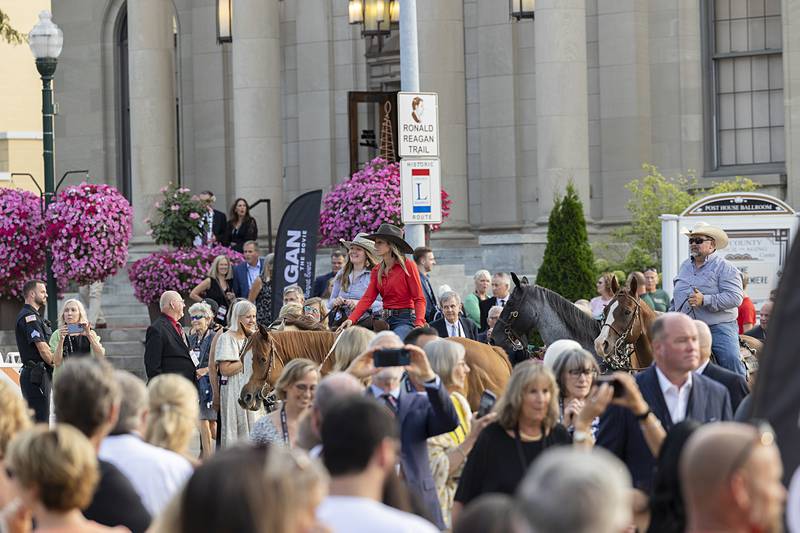 Horseback riders follow a procession from the Ronald Reagan Boyhood Home to The Dixon: Historic Theatre on Thursday, Aug. 22, 2024, for the premier of a movie based on Ronald Reagan.