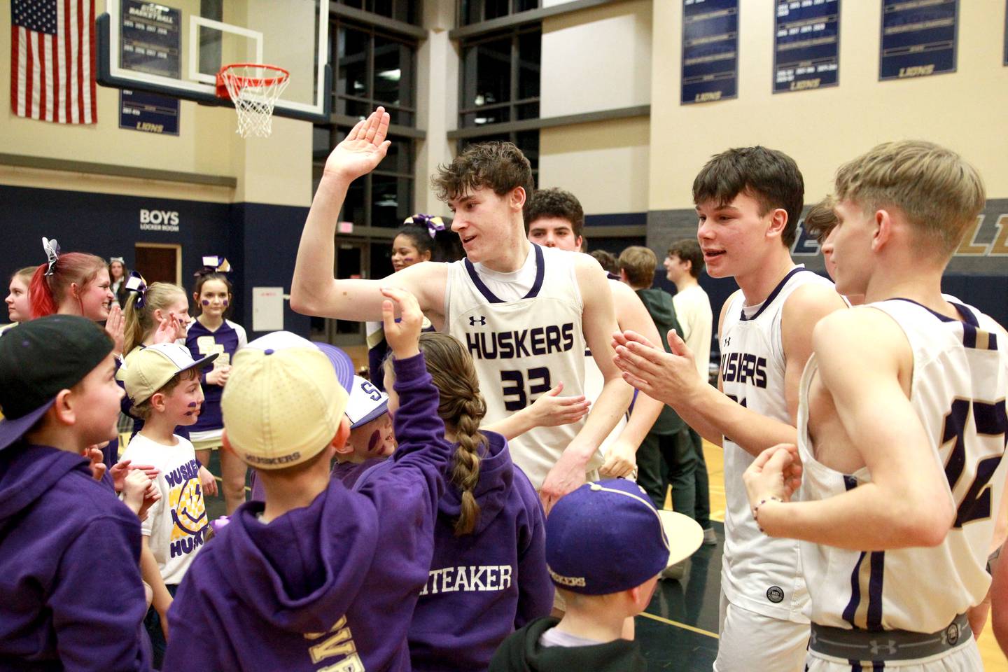 Serena’s Hunter Staton high-fives fans following their Class 1A Harvest Christian Academy Sectional semifinal game win over Harvest Christian Academy on Wednesday, Feb. 28, 2024 in Elgin.