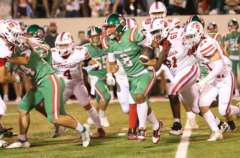 L-P quarterback Marion Perish runs the ball against Ottawa players Logan Mills, Stephon Patrick and Jace Veith on Friday, Sept. 13, 2024 at Howard Fellows Stadium.