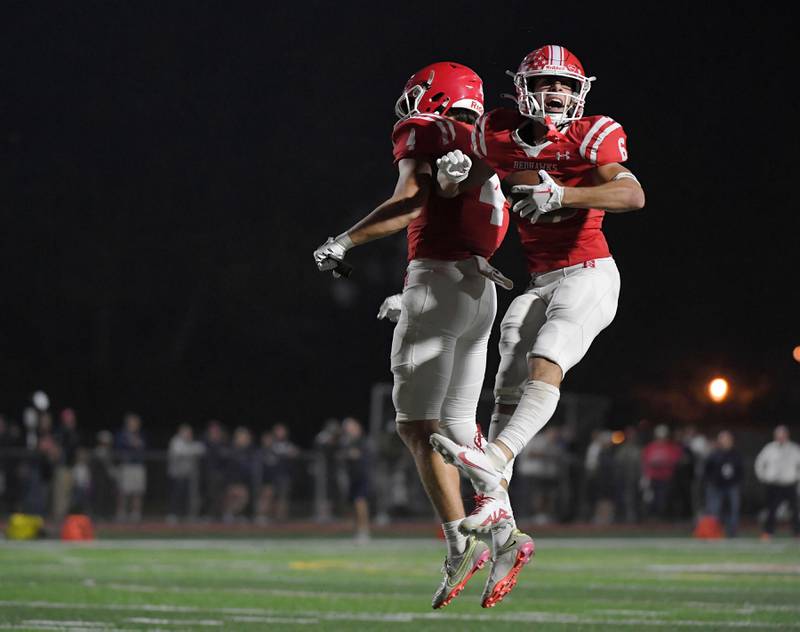 Naperville Central’s Christopher Bern celebrates his second touchdown catch against Naperville North with teammate Logan Ellison in a high school football game at North Central College in Naperville on Friday, Sept. 29, 2023.