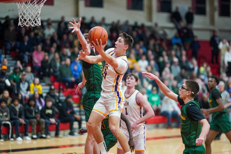 Downers Grove North's Jack Stanton (21) drives to the basket against Waubonsie Valley's Case Valek (25) during a Class 4A East Aurora sectional semifinal basketball game at East Aurora High School on Wednesday, Feb 28, 2024.