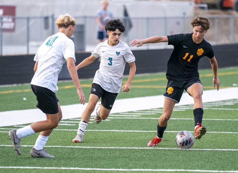 Woodstock North's Jorge Tapia Ortiz, 3,  and Richmond-Burton's Jack Meyer, 11, battle for the ball during their varsity soccer game on Wednesday, September 18, 2024 at Richmond-Burton High School in Richmond.