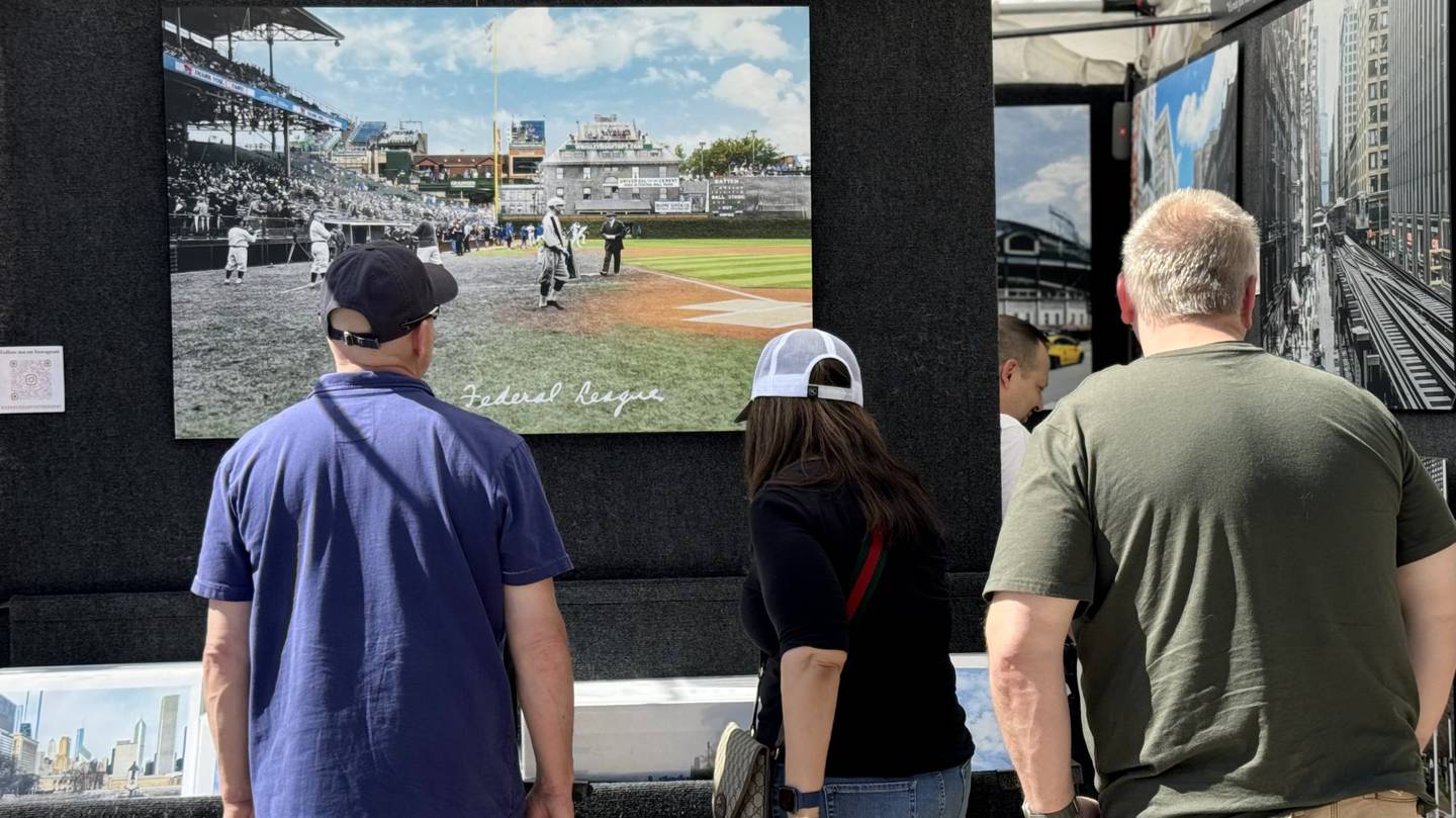 Guests admire photography by Highland Park artist Mark Hersch at the annual Fine Art Show on May 25 and 26, 2024, in downtown St. Charles.