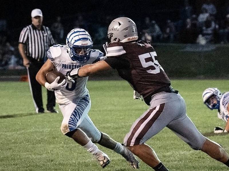 Princeton's Ace Christiansen tries to get past Rockridge's Landon Bull Friday night. The Tigers won 27-18.