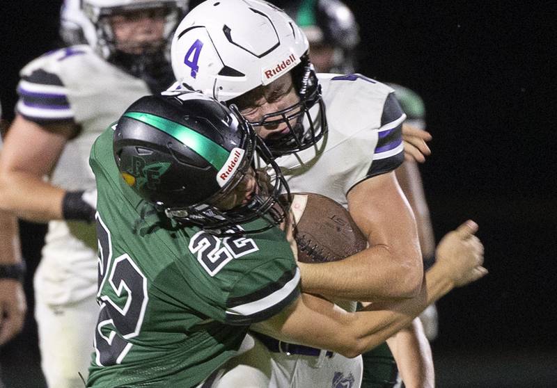 Dixon’s Landon Knigge is hit by Rock Falls’ Cooper South Friday, Sept. 13, 2024, at Hinders Field in Rock Falls.