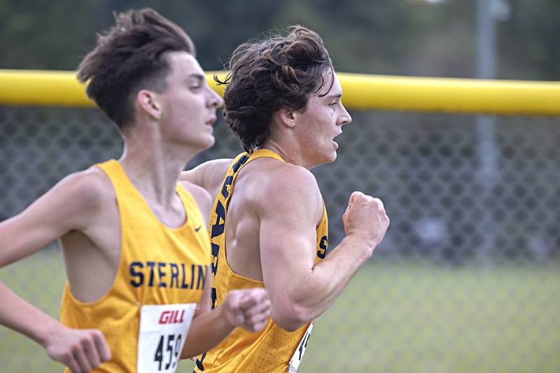 Sterling’s Jordan Britt overtakes teammate Aalin Schmidt for fourth place Tuesday, Sept. 12, 2023 during the Twin Cities Cross Country Meet at Centennial Park in Rock Falls.