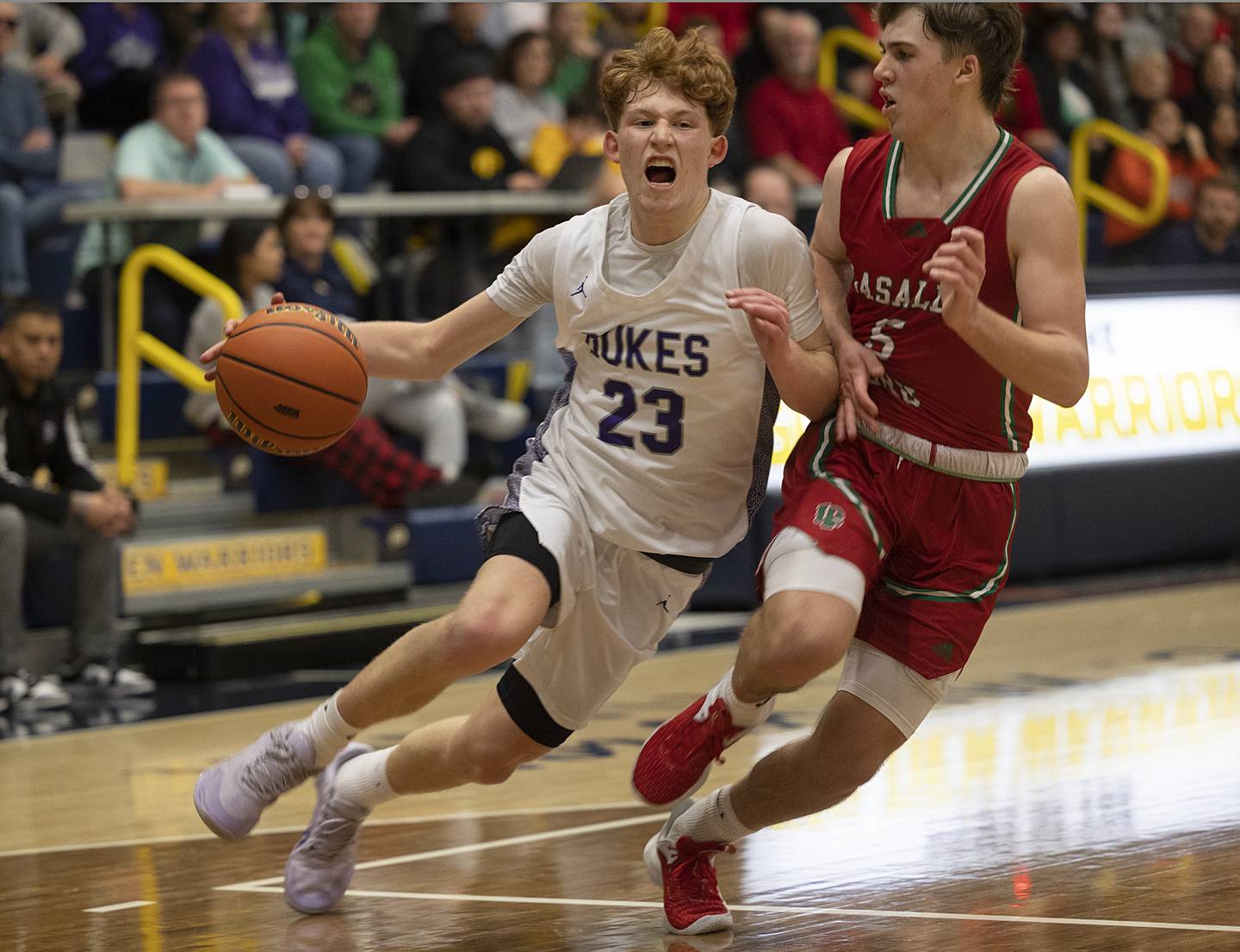 Dixon’s Austin Hicks drives to the hoop while being guarded by LaSalle-Peru’s Brady Romagnoli Wednesday, Feb. 21, 2024 at the Sterling class 3A basketball regional.