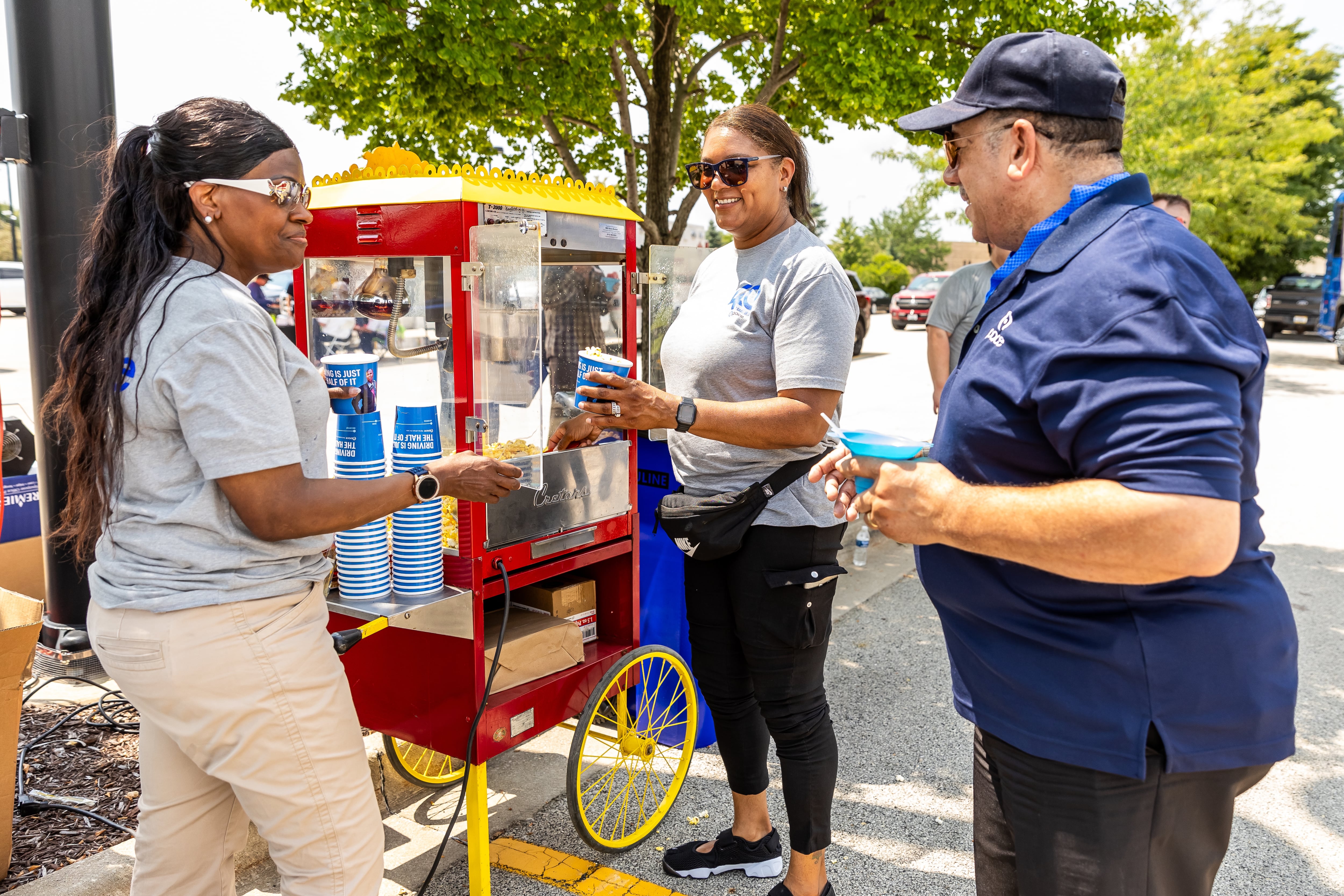 Pace employees, Yana Cruthird, Denise Hanks (a million miler operator), and David Dines enjoy popcorn and more at Activate Joliet on Aug. 3, 2024.