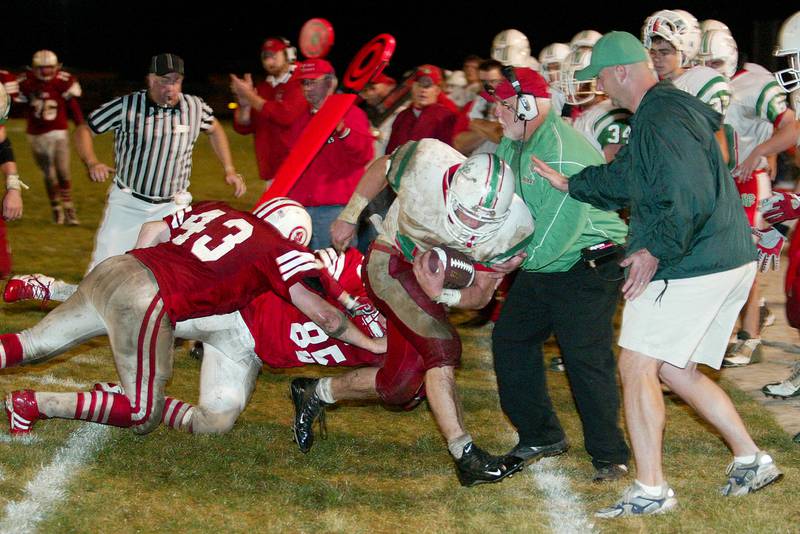 L-P football coaches Mark Siebert and Kevin Keating look to get out of the way during a game against Ottawa in 2004.