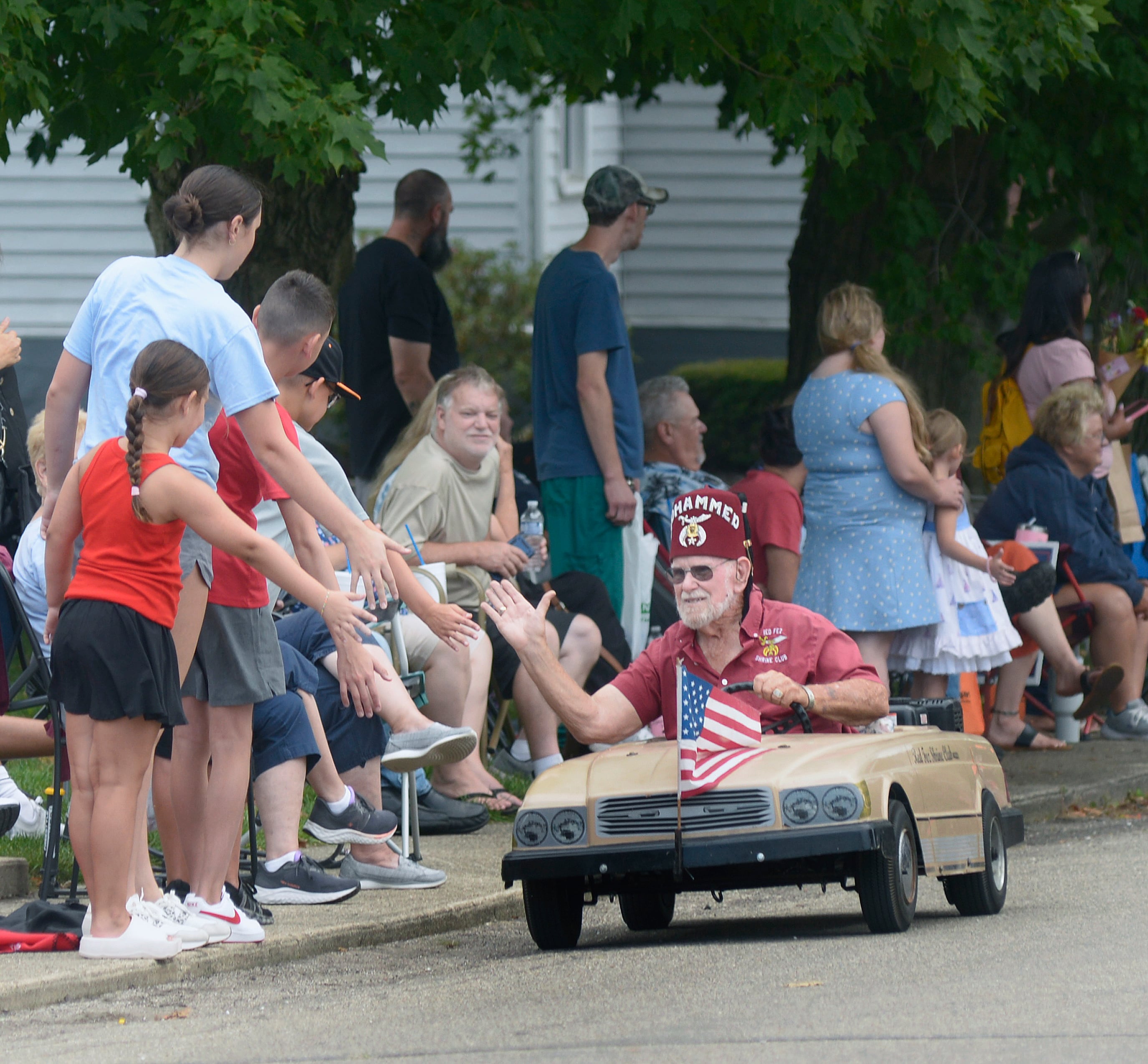 The Red Fez Shrine Club perform driving stunts and greet those along the parade route during the Community Fest Parade Sunday in Grand Ridge.