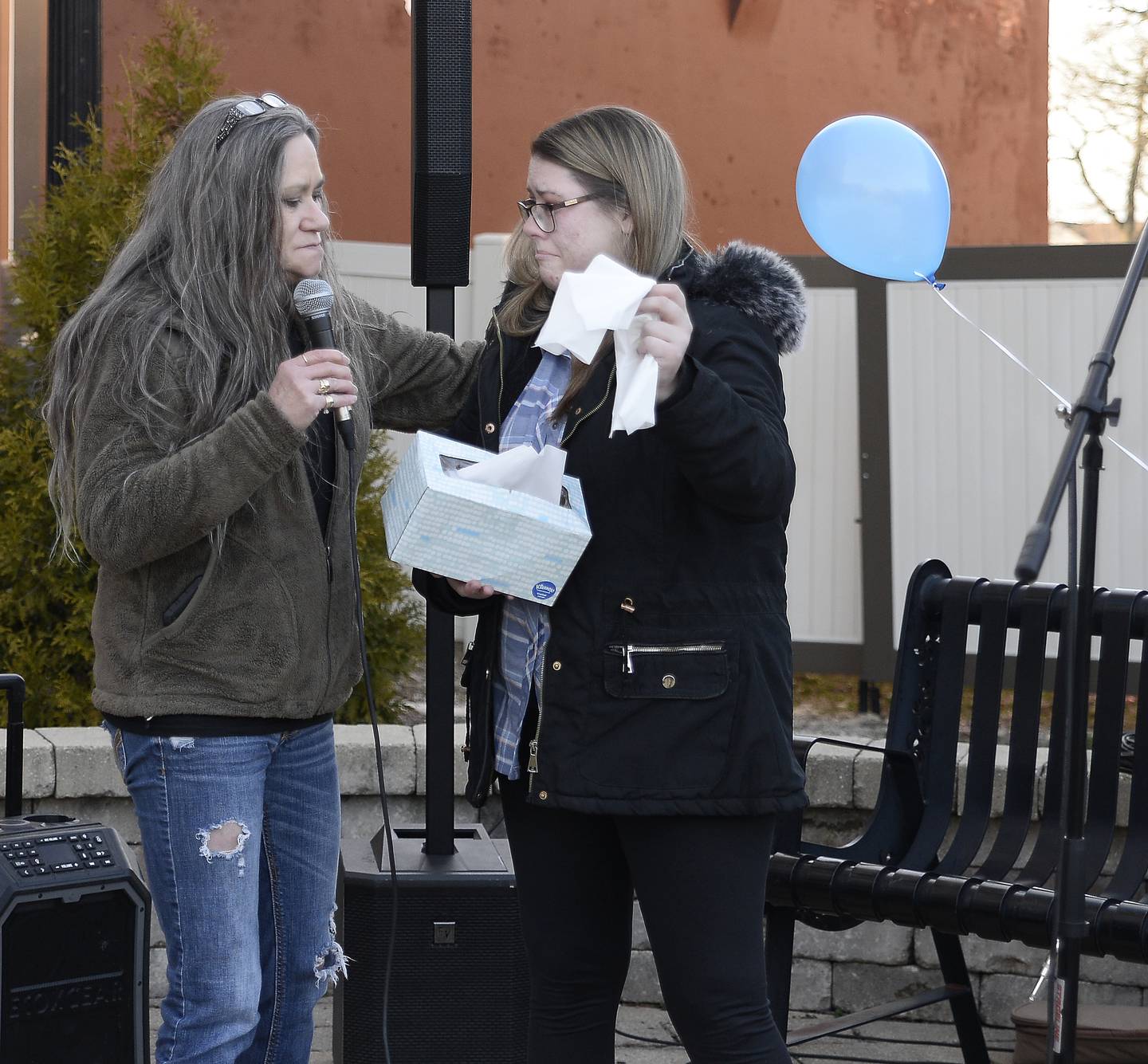 Michelle Mesarchik comforts Maddie Malley, who was a friend and classmate of Dalton Mesarchik, on Sunday, March 26, 2023, at Heritage Park in Streator during a memorial marking the 20th anniversary of Dalton Mesarchik's murder.