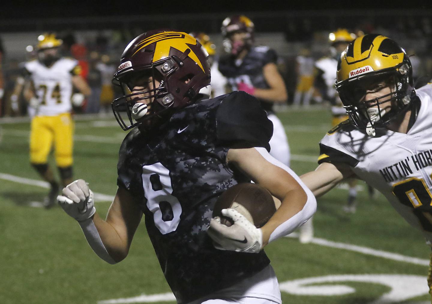 Richmond-Burton's Jack Martens runs for a touchdown as Harvard's Bernard Bahnsen tries to catch him during a Kishwaukee River Conference football game on Thursday, Oct.12, 2023, at Richmond-Burton High School.