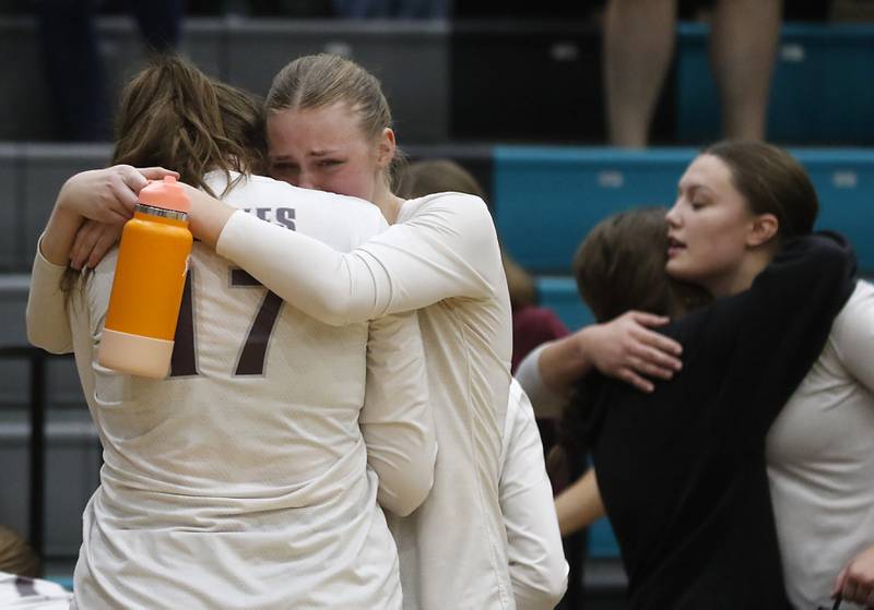 Prairie Ridge's Amelia Bowen (right) hugs Prairie Ridge's Mackenzie Schmidt after Belvidere North defeated Prairie Ridge in the Class 3A Woodstock North Sectional finals volleyball match on Wednesday, Nov. 1, 2023, at Woodstock North High School.