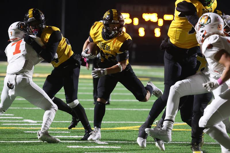 Joliet West’s Gavin Garcia leaps past a block enroute to a touchdown against Plainfield East on Friday, Oct. 13, 2023 in Joliet.