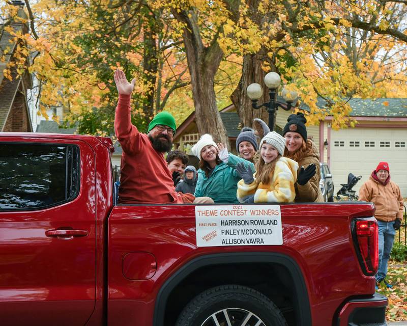 Sycamore’s Pumpkin Festival contest winner Harrison Rowland along with Honorable Mention Finley McDonald and Allison Vavra, as well as their family members wave to the crowd during the Sycamore Pumpkin Festival parade on Sunday Oct. 29, 2023.