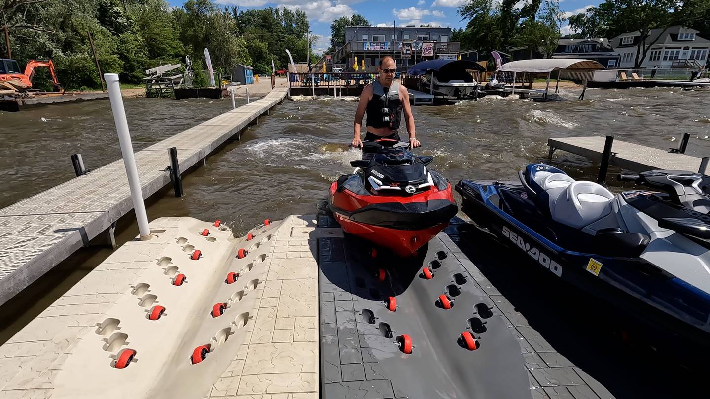 Mike Missak, of McHenry, pulls his PWC onto one of the floating ports at The Beach House on Fox Lake. It is one of seven locations with "parking" for personal watercraft installed with the help of Nielsen Enterprises.