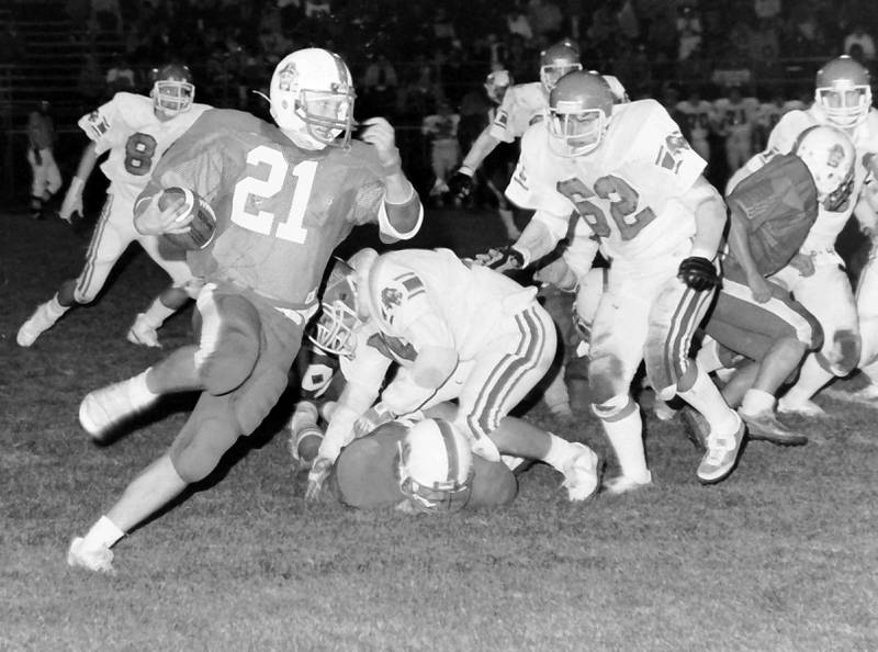 Ottawa running back Erik Burgwald works his way up the field as La Salle-Peru's Jeff Derango looks to pursue in the 1984 game.