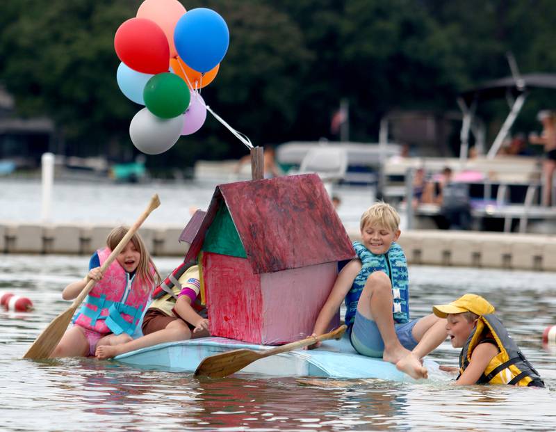 The Edgebrook Explorers group paddles through the Cardboard Regatta on Crystal Lake Saturday.