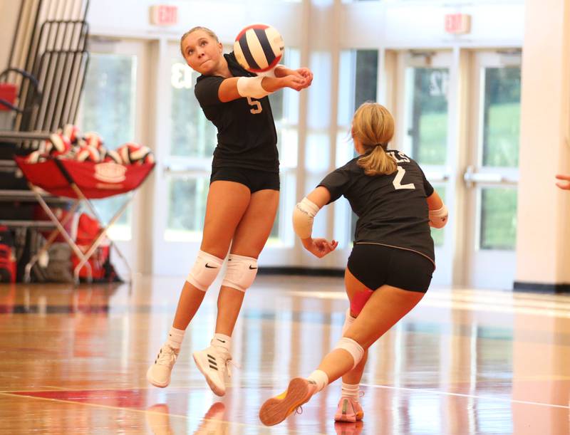 Hall's Charlie Pellegrini returns a serve from Mendota as teammate Evelyn Bryant watches on Tuesday, Sept. 13, 2024 at Hall High School.