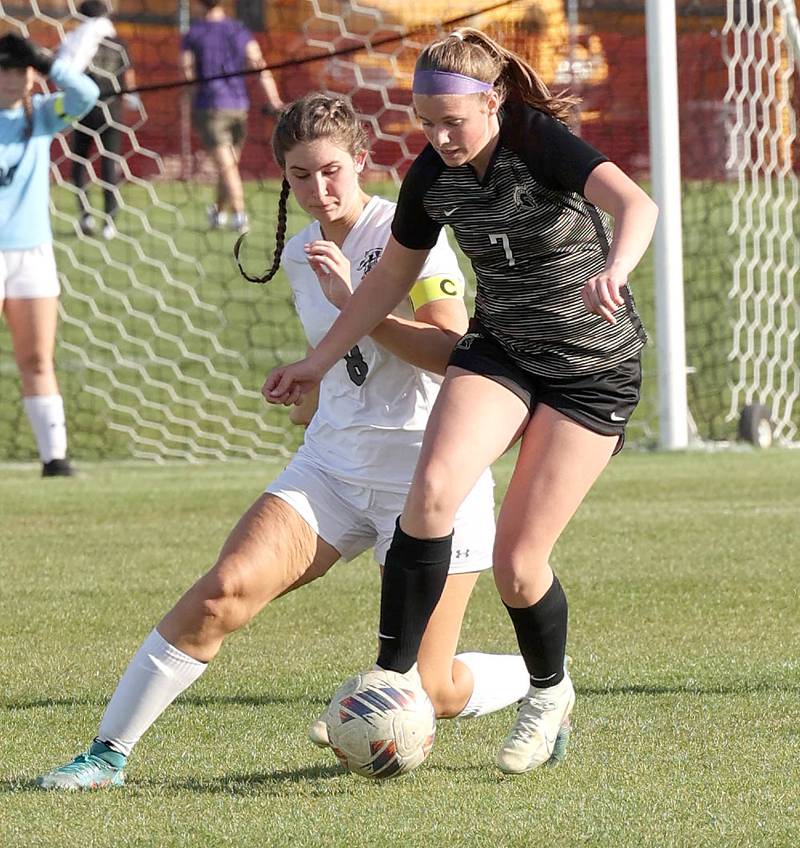 Sycamore's Peyton Wright tries to hold off Kaneland's Emily Kunzer Friday, April 28, 2023, during their game at Sycamore High School.