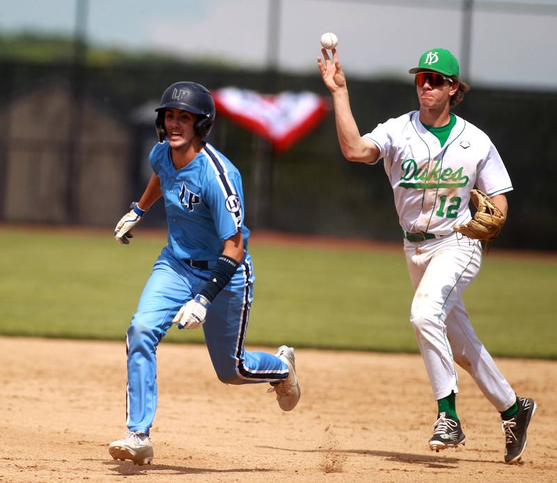 York’s Josh Fleming chases down Lake Park baserunner James Kelley during a Class 4A St. Charles North Sectional semifinal game on Wednesday, May 29, 2024.