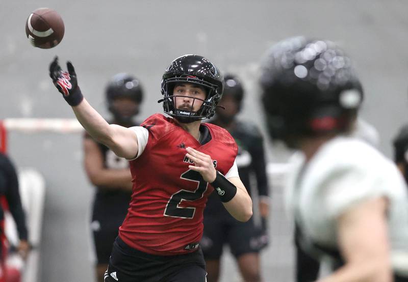 Northern Illinois University quarterback Ethan Hampton throws a pass to receiver Dane Pardridge Tuesday, March 26, 2024, during spring practice in the Chessick Practice Center at NIU in Dekalb.