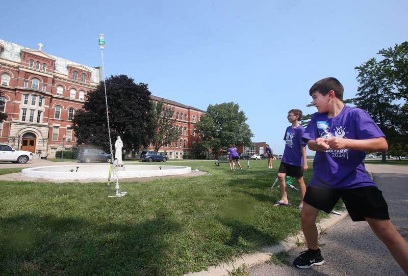 Mason Atherton pulls a rip cord on a water rocket during the 22nd annual Carus Summer Science Camp on Friday, July 12, 2024 at St. Bede Academy.