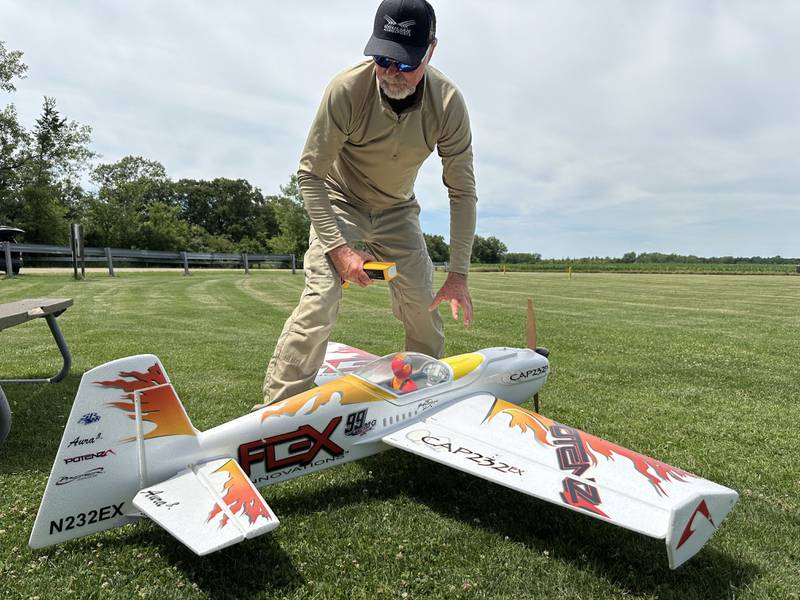 Larry Moore of Oglesby, and member of The Deer Park RC Flyers Club, removes a battery from his Flex QQ Cap 232EX model airplane on Monday, July 1, 2024 at the Model Airplane Field in Matthiessen State Park. The Deer Park RC Flyers radio-controlled aircraft club maintains the model airplane field and flies model airplanes at the site.