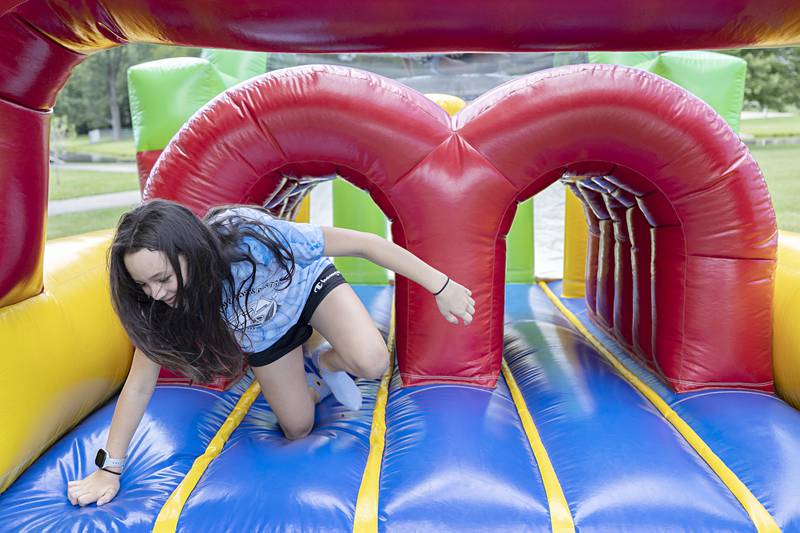 Prestyn Pope, 10, of Rock Falls comes out of an inflatable obstacle course Thursday, July 20, 2023 on the final day of the Coloma Park District field trip program. The program allowed campers to experience lots of fun activities and see many unique places.