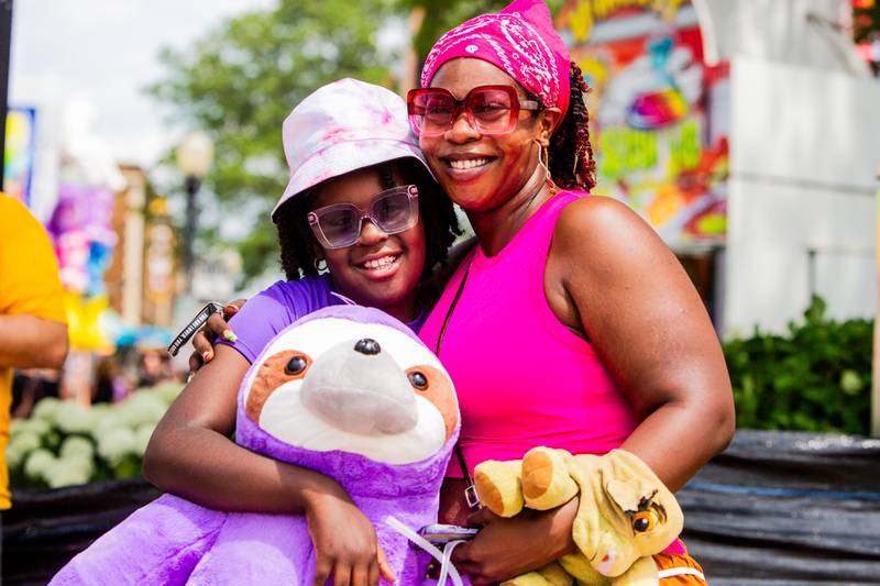 Amira Coleman, 8, of Bolingbrook holds onto the large stuffed sloth she won with Ashley Harvey during the Downer’s Grove Rotary Fest, Saturday, June 22. 

Suzanne Tennant/For Shaw Local News Media