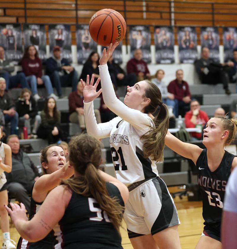 Kaneland's Kyra Lilly gets up a shot between three Prairie Ridge defenders Thursday, Feb 15, 2024, during their Class 3A regional final game at Kaneland High School in Maple Park.