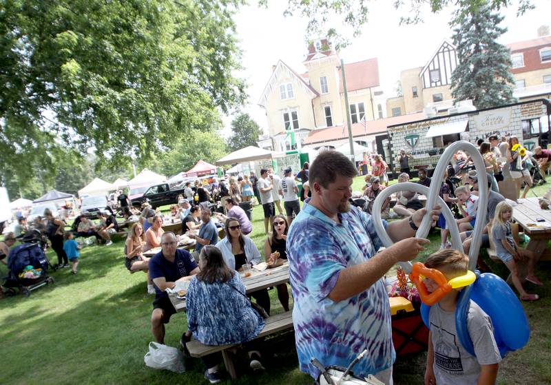 A balloon artist from RC Juggle plies his trade as part of The Dole Farmers Market in Crystal Lake Sunday.