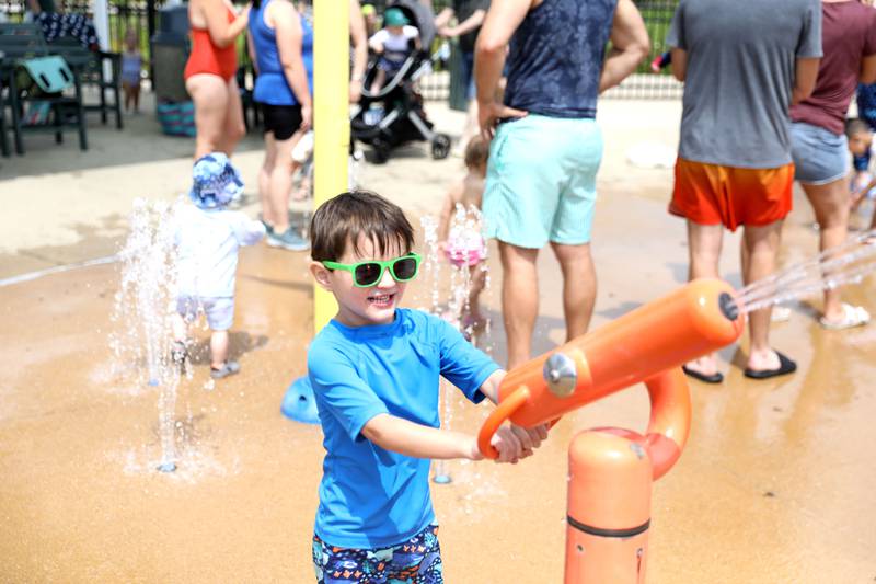 Brayden Atkinson, 5, shoots a water gun at the Maryknoll Splash Park in Glen Ellyn on Saturday, June 15, 2024.