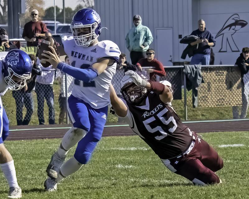 Newman’s JJ Castle scrambles away from a Rockridge tackler in round one of football playoffs Saturday, Oct. 29, 2022.