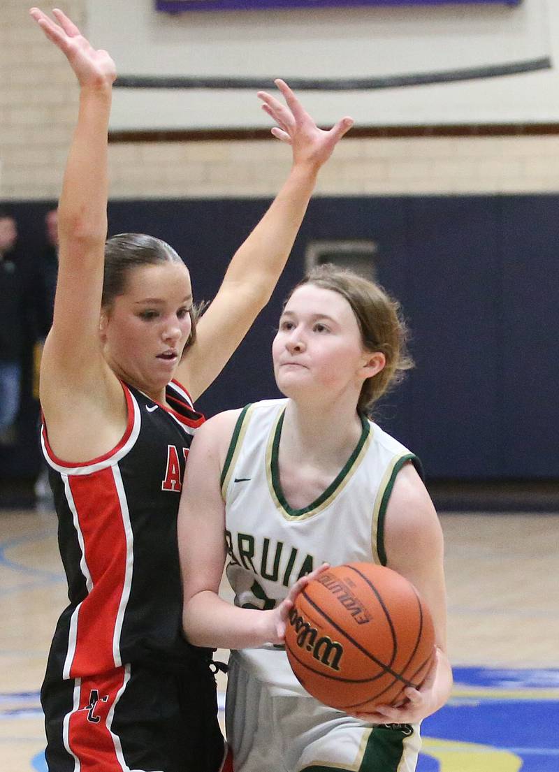 St. Bede's Lili McClain eyes the hoop as she works her way around Amboy's Elly Jones during the Class 1A Regional final game on Friday, Feb. 16, 2024 at Marquette High School.