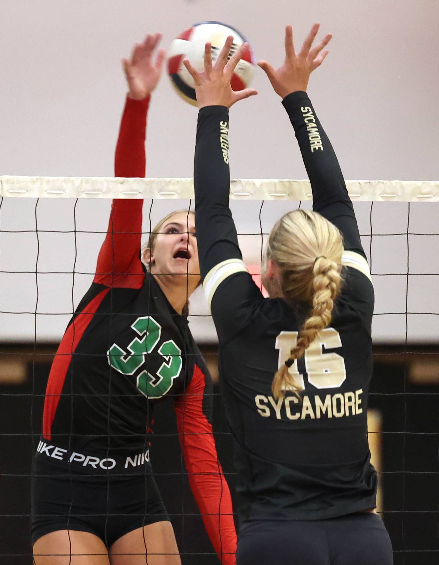 LaSalle-Peru's Kelsey Frederick tries to spike the ball by Sycamore's Jaycie Funderburg during their match Tuesday, Oct. 10, 2023, at Sycamore High School.