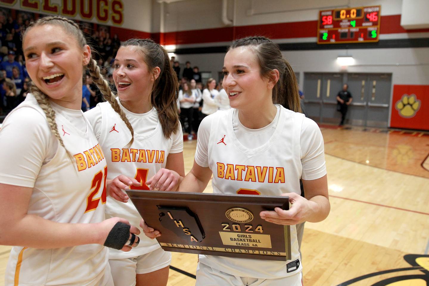 Batavia players (from left) Kylee Gehrt, Addi Lowe and Brooke Carlson celebrate their Class 4A Batavia Sectional final win over Geneva on Thursday, Feb. 22, 2024.