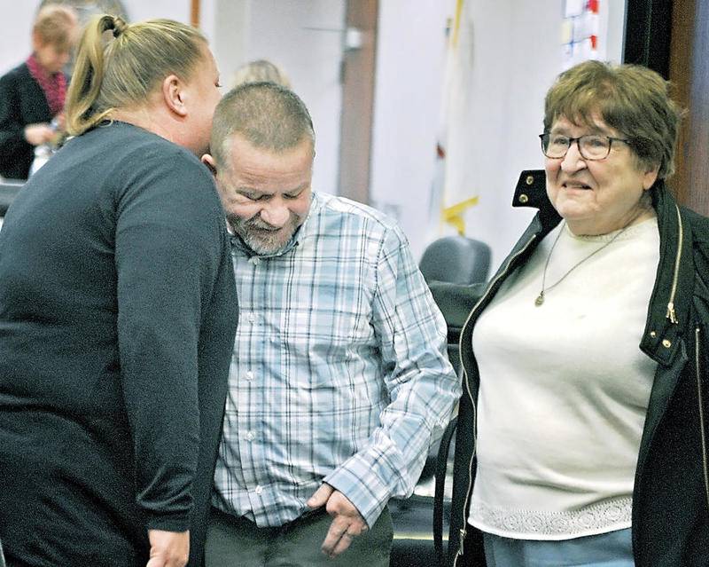 Kenneth Cusick gets a hug from a family member on his way out of an Ottawa courtroom in December 2019 accompanied by his mother, Sheila Wilson (right). Cusick was found not guilty of the murder of his wife, who died in 2006.