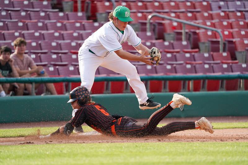 McHenry's John Stecker (6) beats the throw to York's Nick Allen (22) for a triple during a class 4A Kane County supersectional baseball game at Northwestern Medicine Field in Geneva on Monday, June 3, 2024.