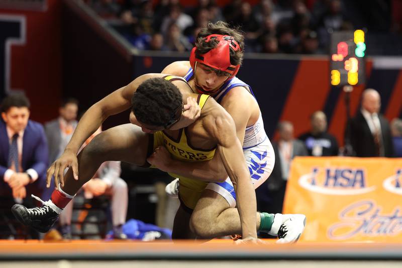 Marmion’s Zach Stewart brings down Lockport’s Justin Wardlow in the 138-pound Class 3A state championship match on Saturday, Feb. 17th, 2024 in Champaign.