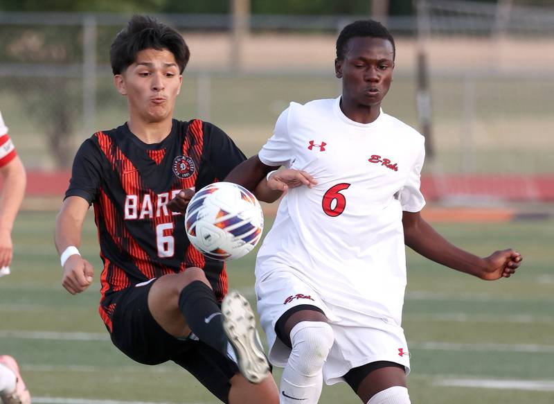 DeKalb's Mauricio Jasso (left) kicks the ball away from Rockford East's Joseph Numbi during their game Thursday, Sept. 12, 2024, at DeKalb High School.