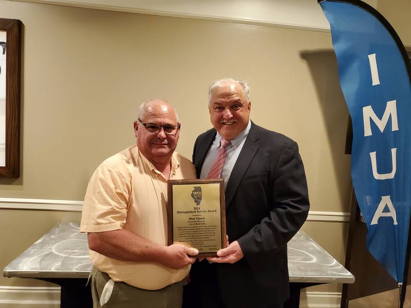 City of Rock Falls Electrical Director Dick Simon (left) receives the 2024 IMEA/IMUA Distinguished Service Award from Kevin Gaden.