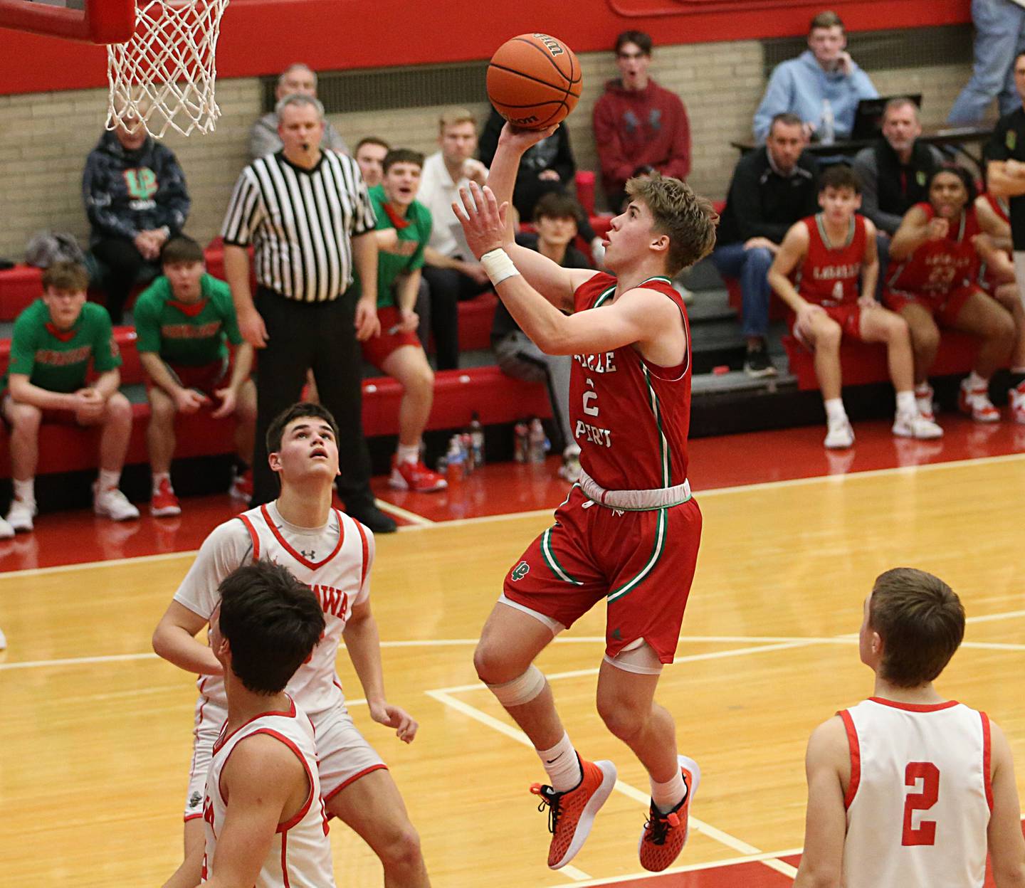 L-P's Seth Adams runs in the lane to score over Ottawa's Cooper Knoll in Kingman Gymnasium on Friday, Feb. 10, 2023 at Ottawa High School.