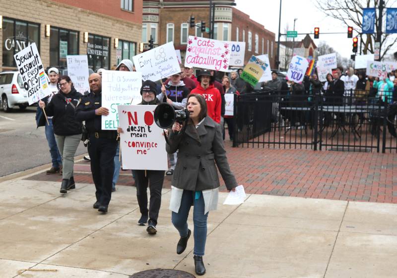 Kelsey Gettle, Safe Passage legal program manager, leads marchers back to the Egyptian Theatre Tuesday, April 2, 2024, during Take Back the Night in DeKalb. The event, hosted by Safe Passage, is in honor of Sexual Assault Awareness Month and featured speakers and a march.