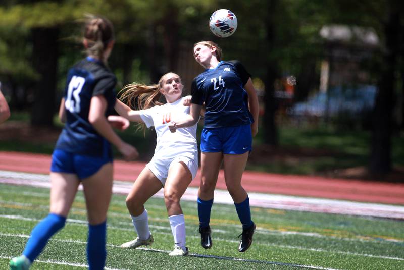 Crystal Lake Central’s Brooklynn Carlson (left) watches as Burlington Central’s Alison Kowall heads the ball during the Class 2A state semifinal game at North Central College in Naperville on Friday, May 31, 2024.